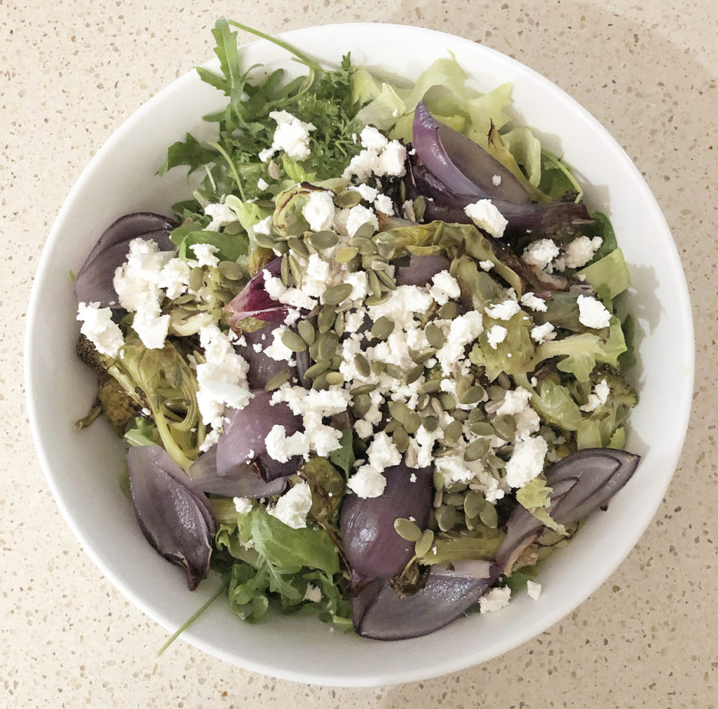 Roast cabbage, broccoli and onion salad with seeds and goats cheese