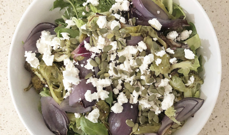 Roast cabbage, broccoli and onion salad with seeds and goats cheese